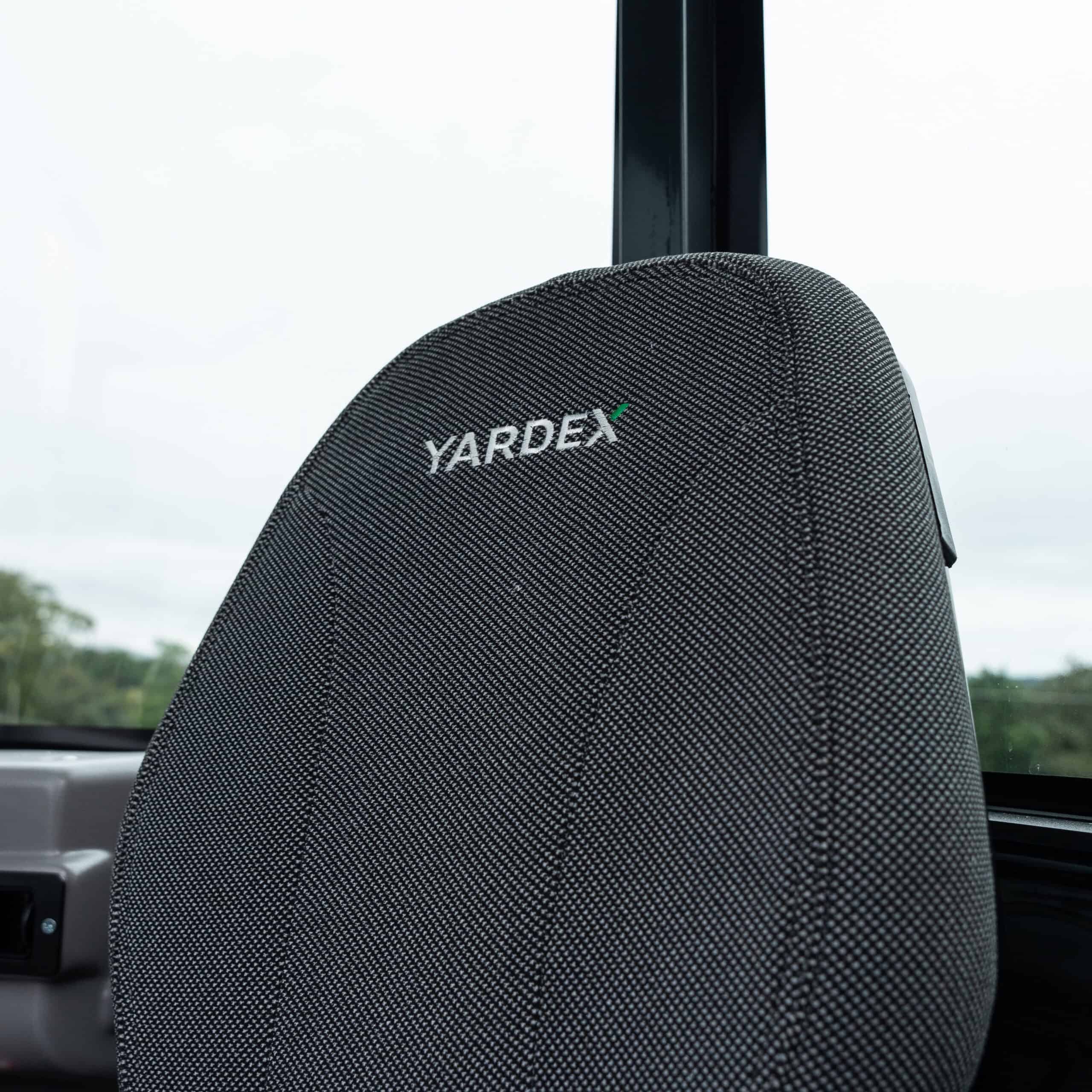 Bus seat with Yardex branding in a vehicle interior.