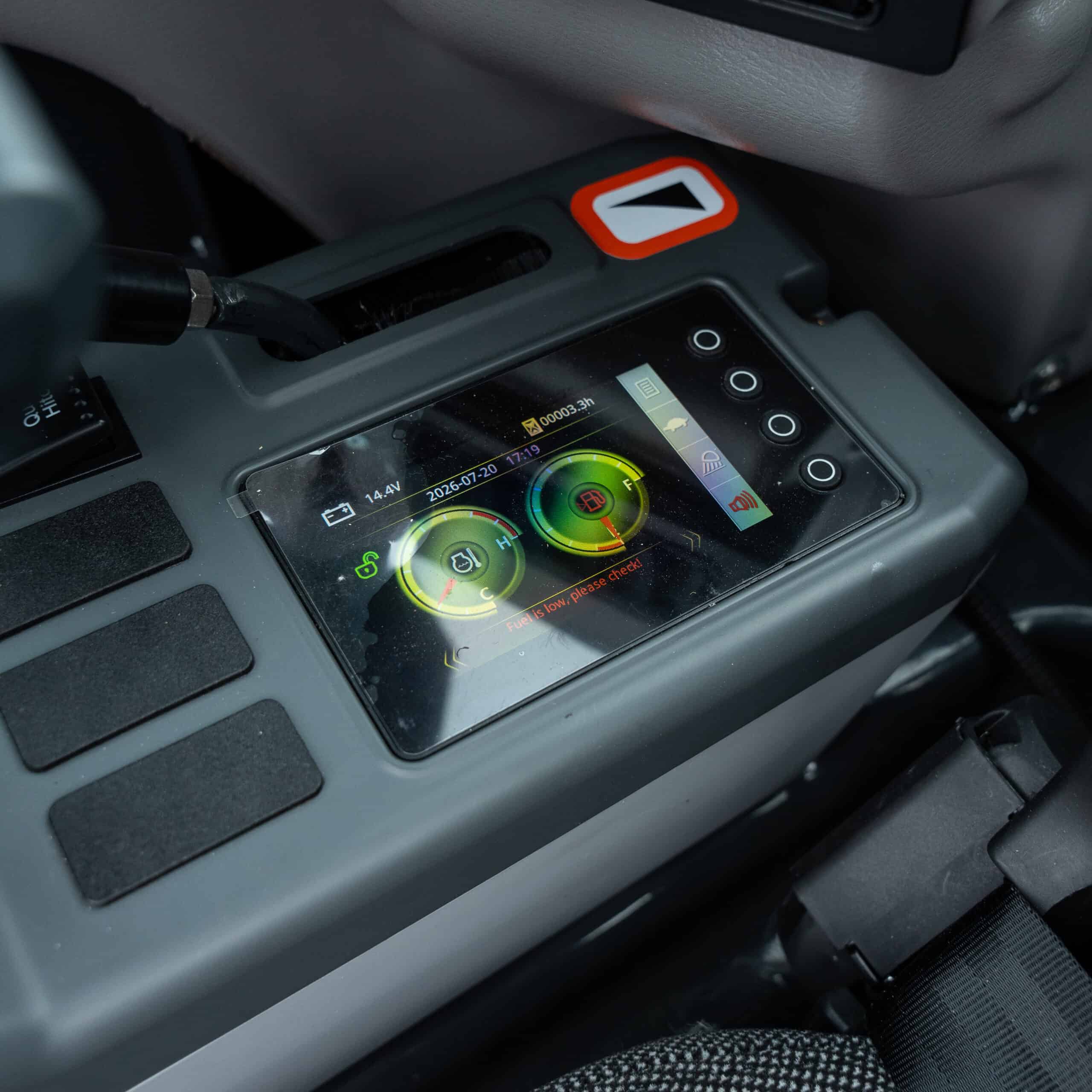 Close-up of a digital equipment monitoring device in a vehicle.