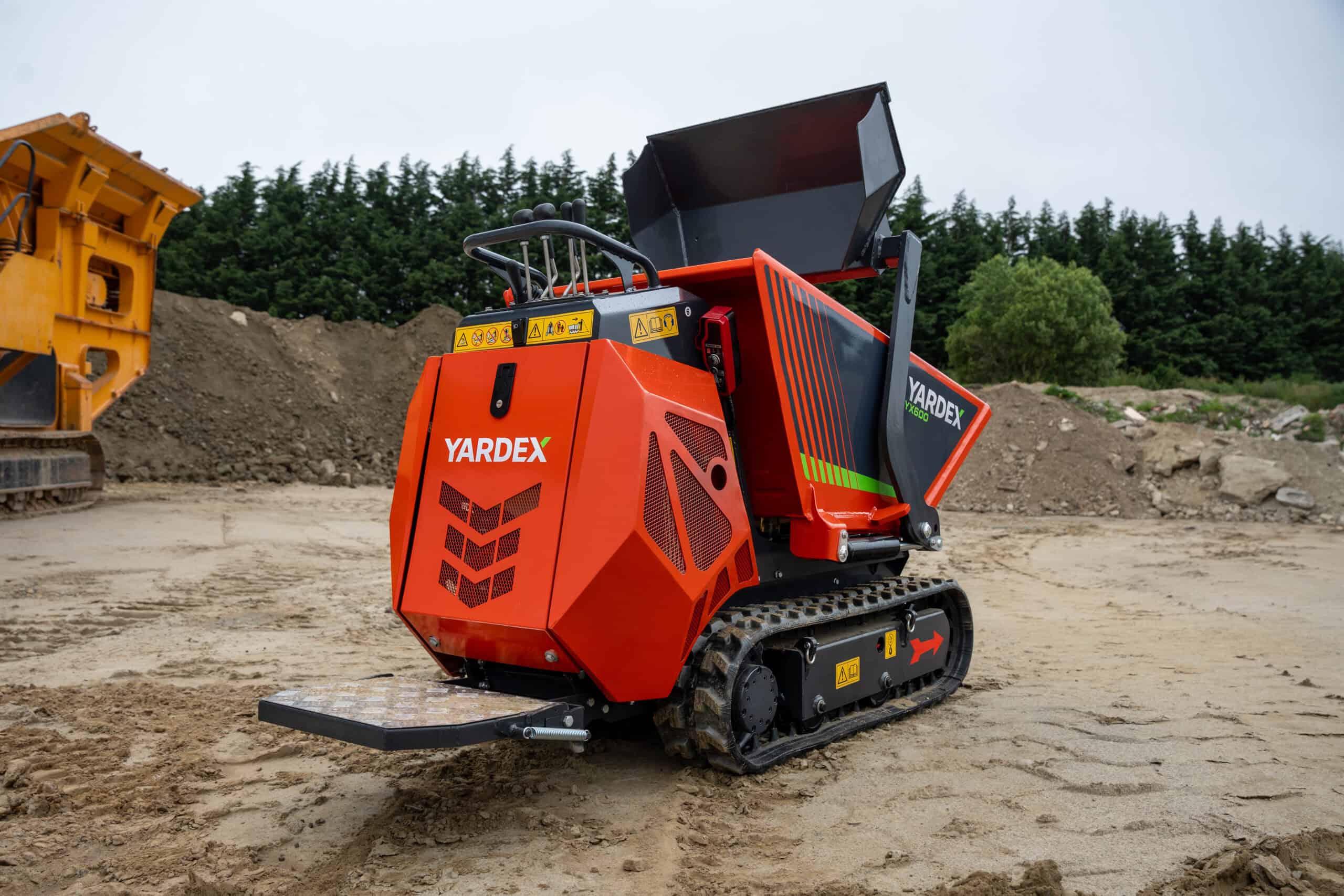 Yardex Group compact construction robot on construction site with tracked wheels.