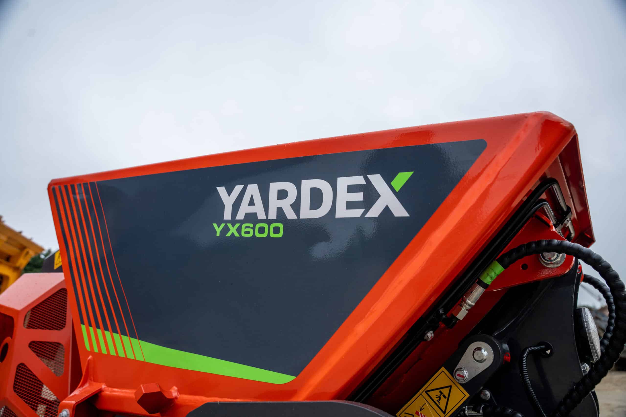 Close-up of Yardex YX600 industrial equipment with branding and safety labels.