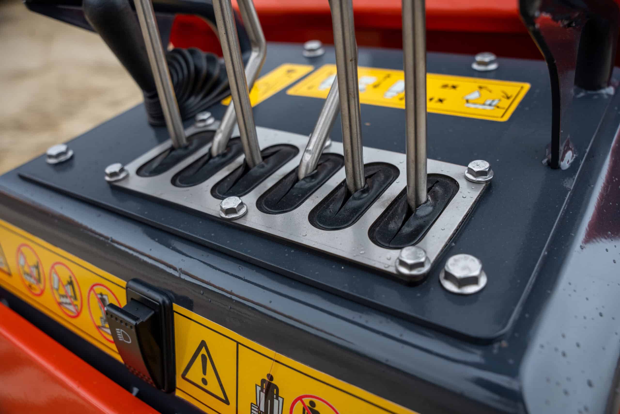 Close-up of control levers on Yardex Group construction equipment.