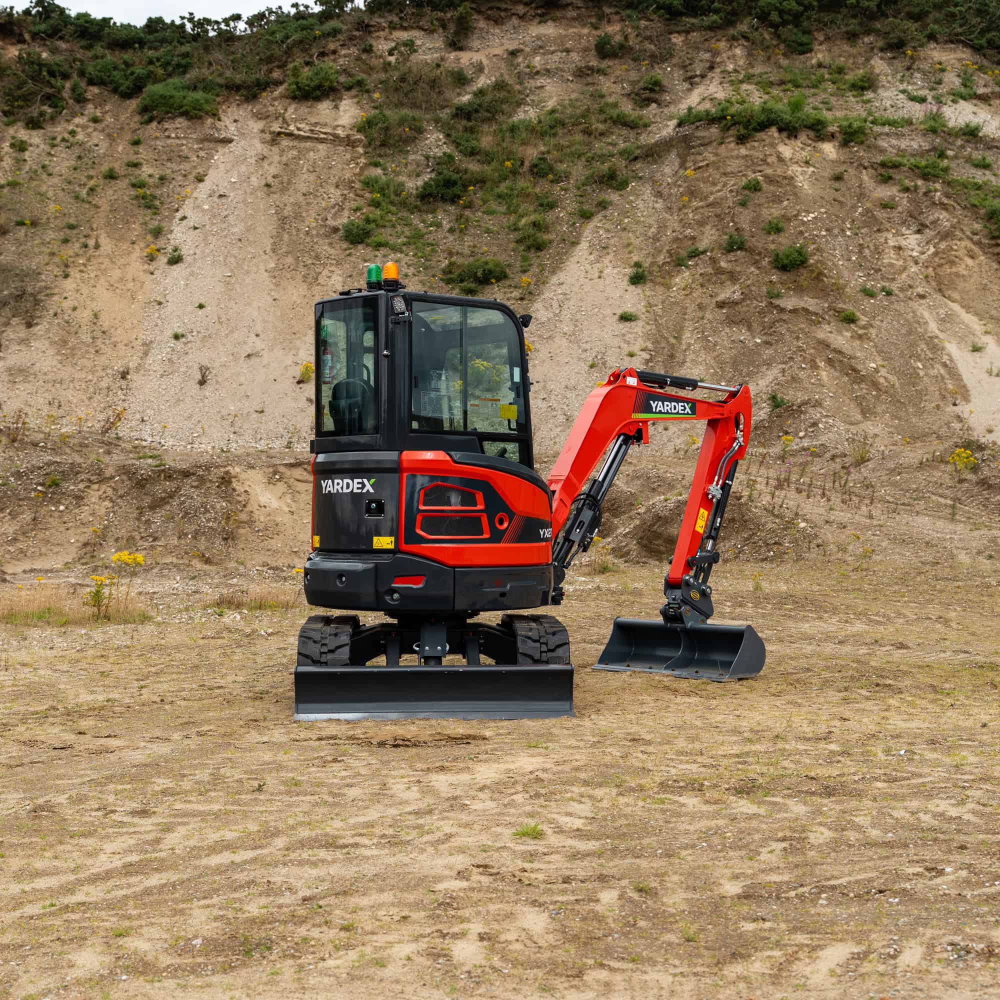 Yardex compact mini excavator working on construction site.
