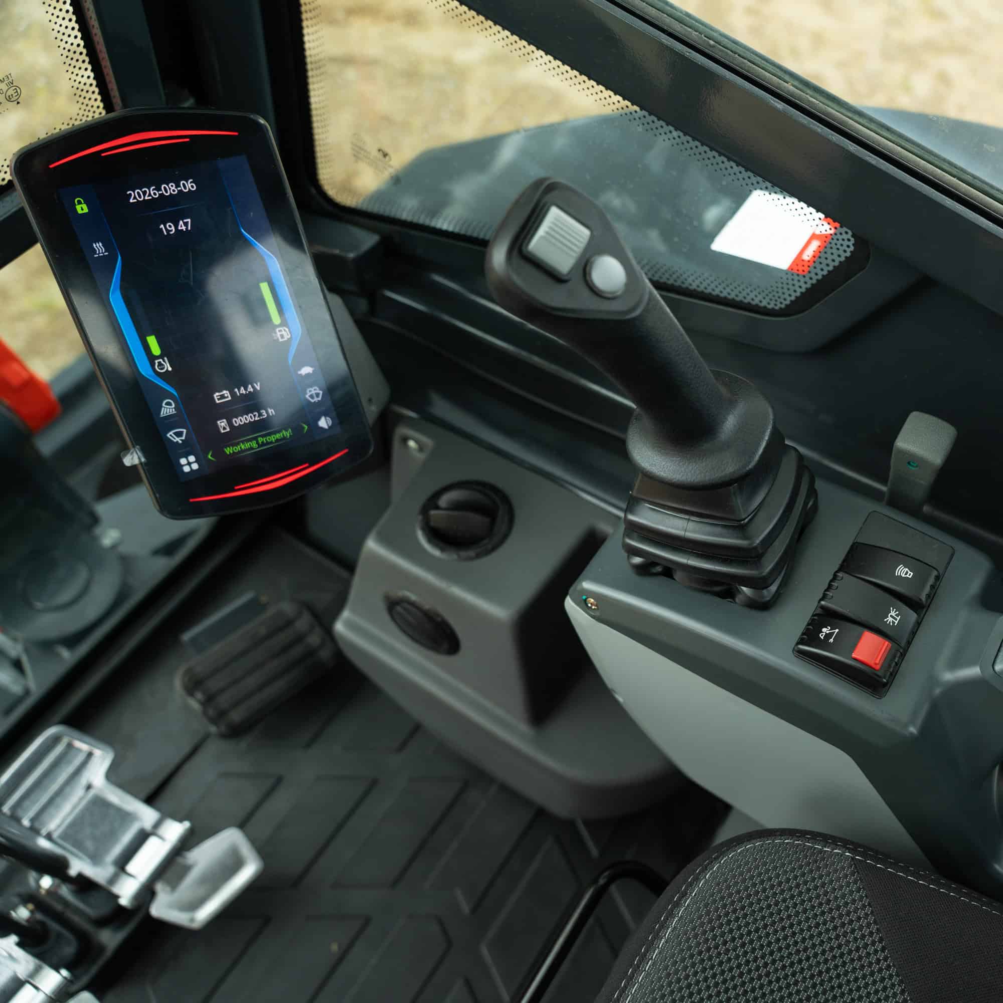 Close-up of control panel and digital display in construction equipment.