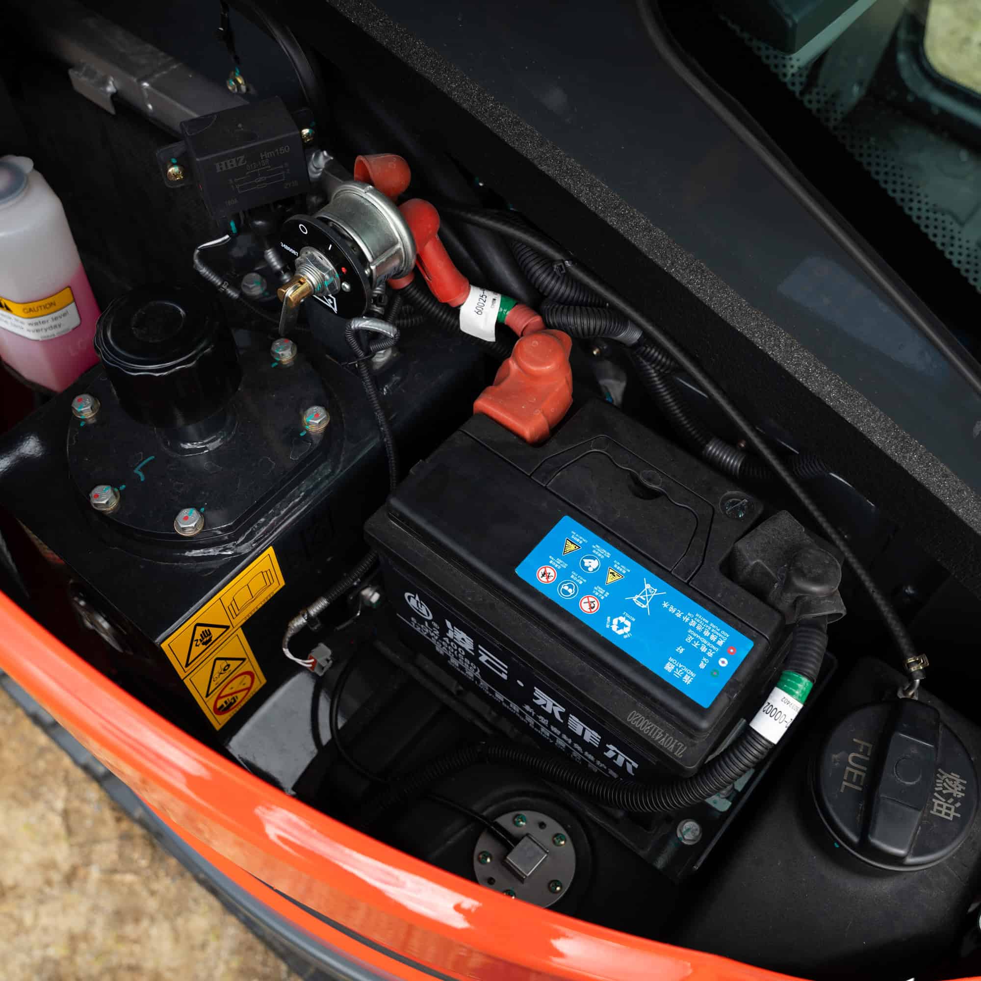 Close-up of Yardex Group machinery engine and battery components.