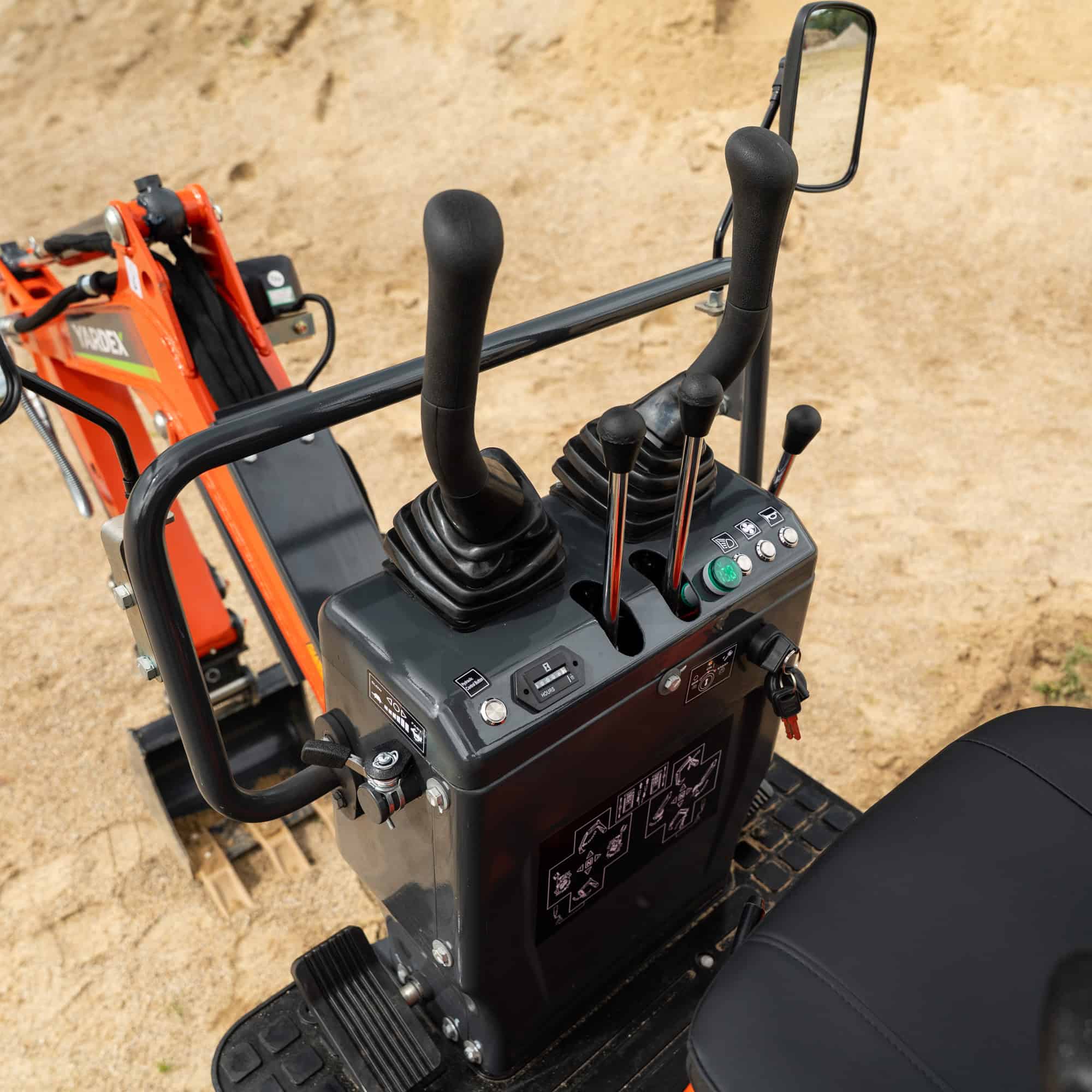 Close-up of control panel and joysticks of Yardex Group compact excavator.