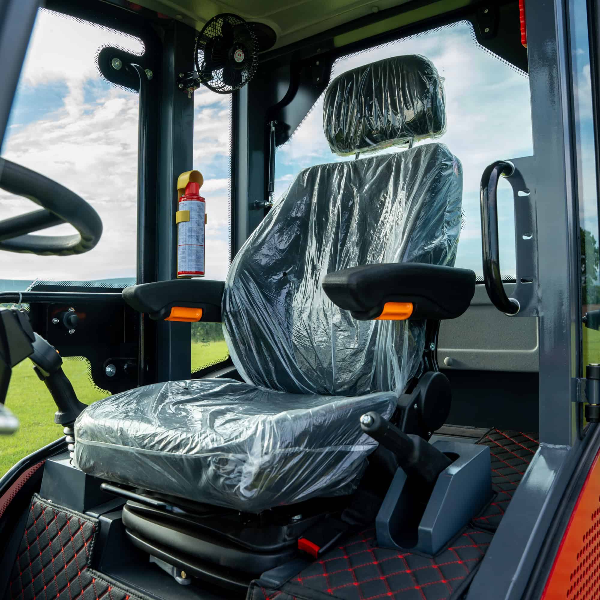 Interior view of a Yardex Group construction vehicle cabin with safety features.