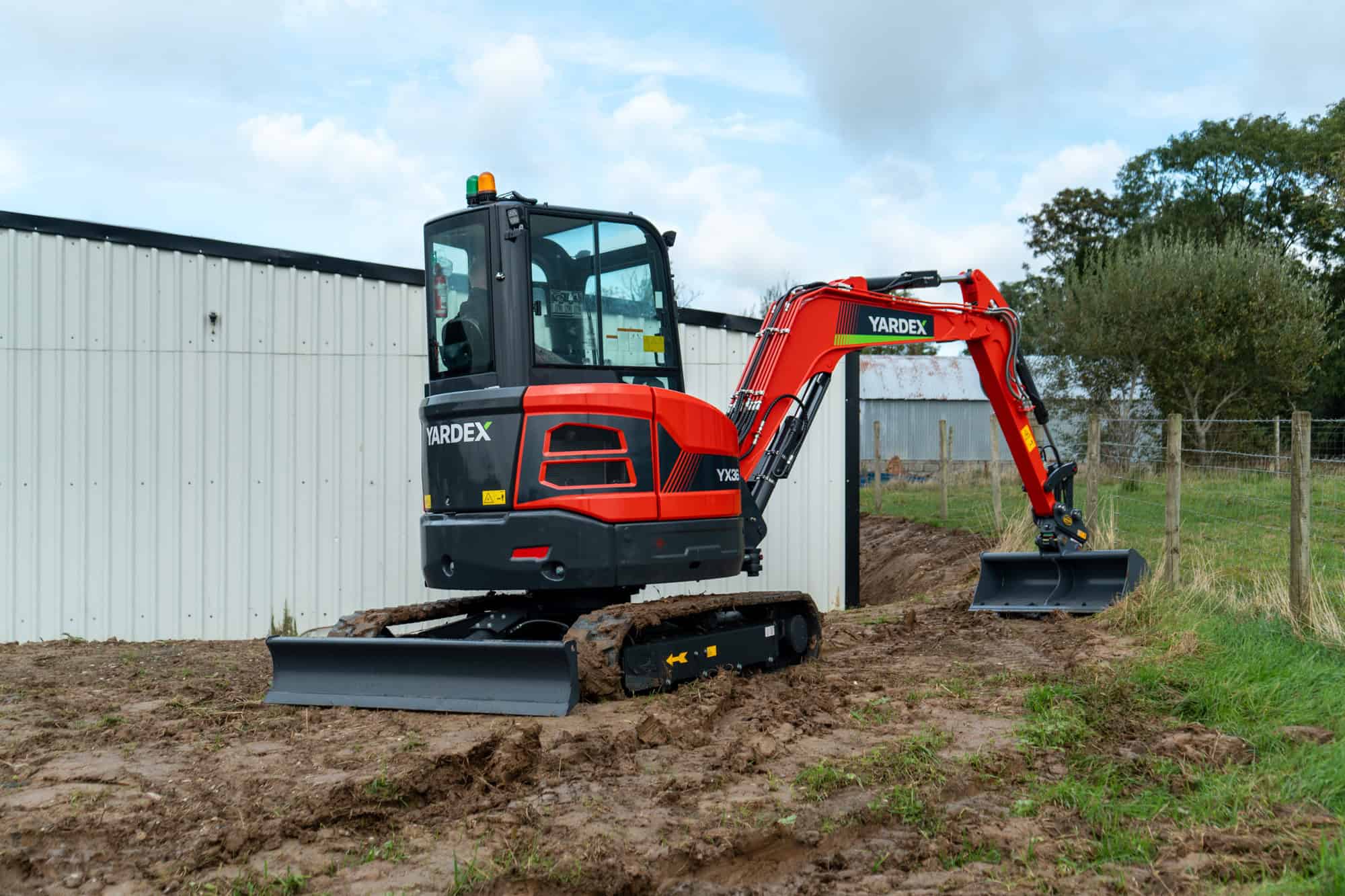 Yardex Group compact excavator working on a construction site.